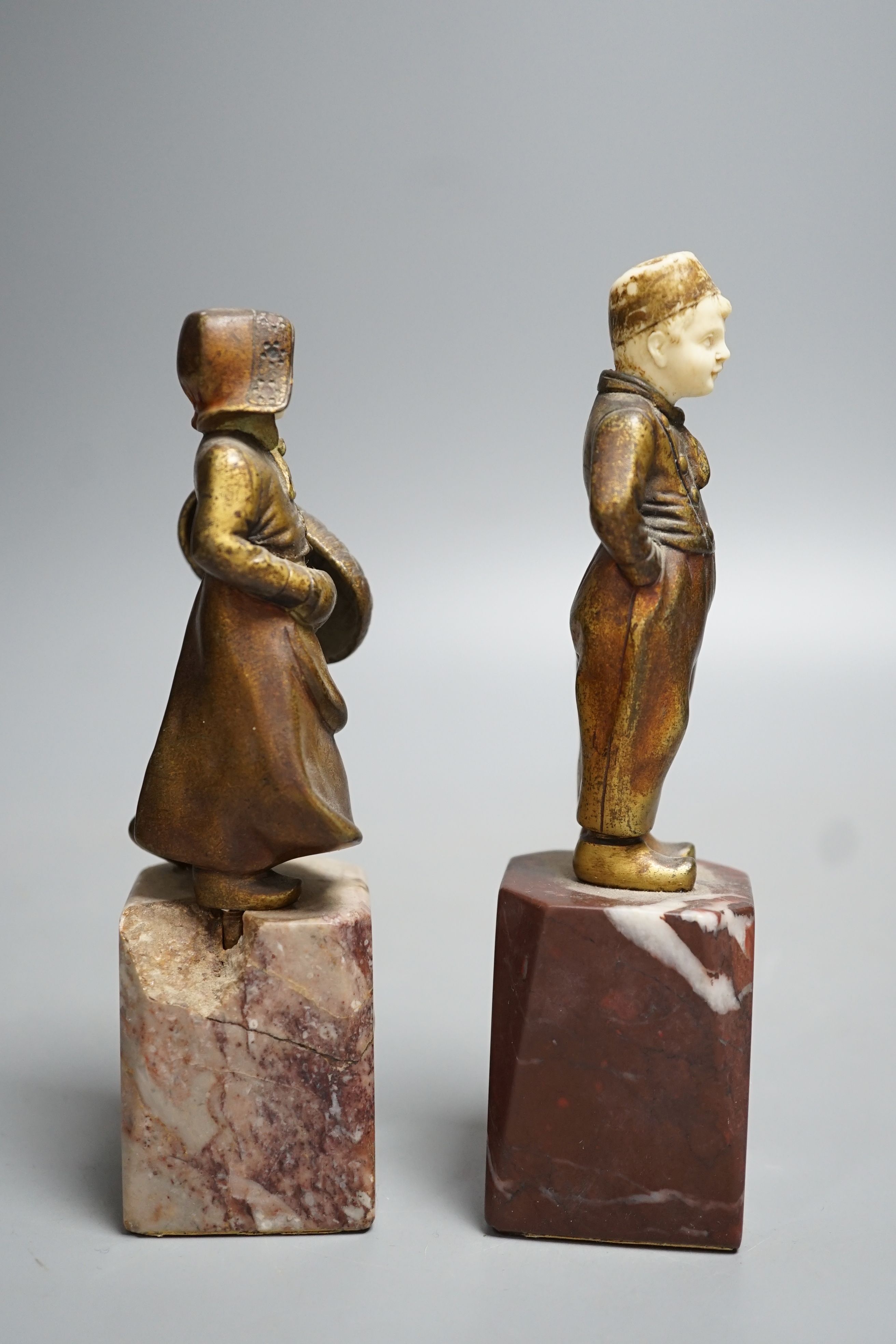 Two Art Deco gilt bronze and ivory Dutch youths, on marble plinths (one a.f) 15cm